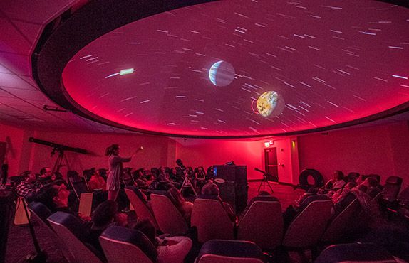 People enjoying a show at the WVU planetarium