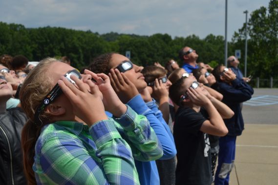 Solar eclipse day at WVU, students wearing solar eclipse glasses